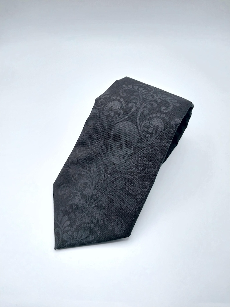 May include: Black tie with a skull and floral pattern.