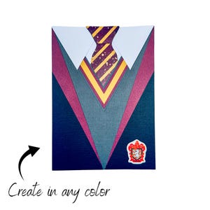 May include: A papercraft design of a Hogwarts school uniform with a burgundy, gray, and navy blue color scheme. The uniform features a yellow and burgundy striped tie with gold glitter accents. The design includes the Hogwarts crest.