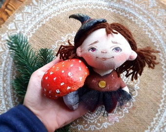 The Little Witch doll with a fly agaric mushroom