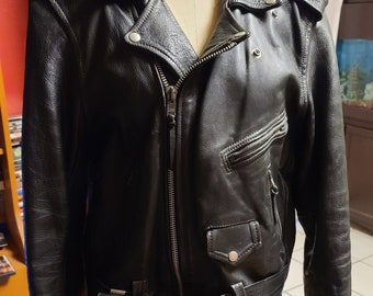May include: Black leather motorcycle jacket with a zip closure, a belt, and a zipped pocket on the left side. The jacket has a "Zipper" brand name on the belt.