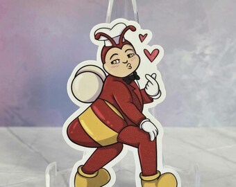 Puede incluir: Una pegatina troquelada que muestra un personaje de abeja de dibujos animados con un gorro de chef blanco, una chaqueta roja con pajarita negra y pantalones amarillos. El personaje tiene un cuerpo blanco redondo, hace un gesto de corazón.