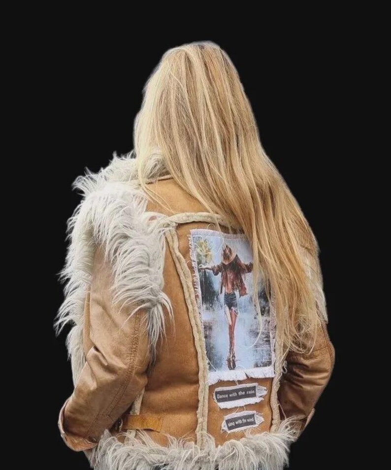 Close-up of soft suede texture and faux fur trim on a boho-style vest.