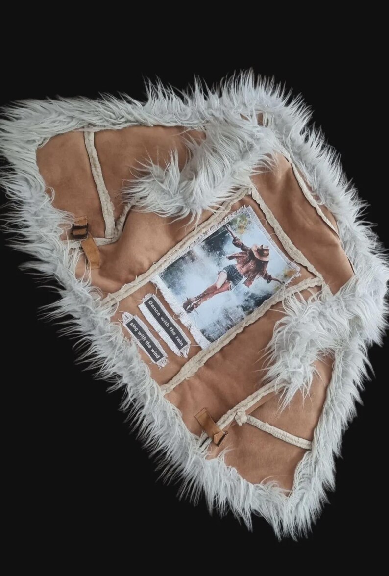 Handmade suede vest with bold statement patch, bohemian rock and western inspired fashion.