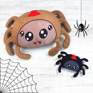 May include: Two plush spider toys. The larger spider is brown with a red heart on its head and large, black eyes. The smaller spider is black with red accents and smaller, black eyes.