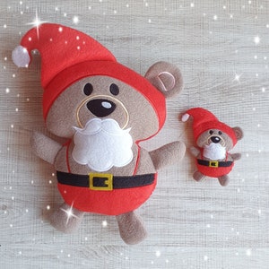 May include: Two plush toy bears dressed as Santa Claus. The larger bear is wearing a red hat and a white beard. The smaller bear is wearing a red hat and a white beard. Both bears have brown fur.