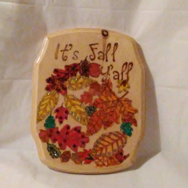 It's Fall Y'all wood burned  plaque painted with orange, green, red and yellow leaves