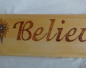 Believe wood burned sign with star painted and embellished with colored crystals