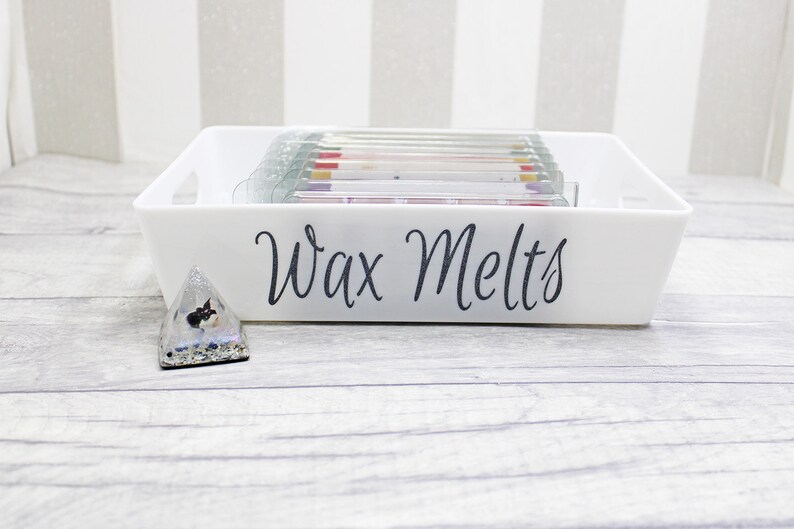 May include: White rectangular tray with the text "Wax Melts" on the front. The tray is filled with small, colorful wax melts.