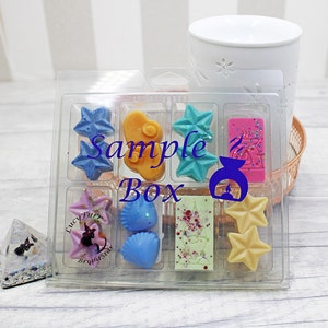 May include: A clear plastic box filled with small wax melts in various shapes and colours. The box is labelled "Sample Box".