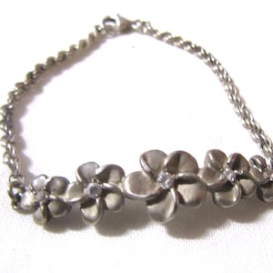 May include: A set of three ceramic mugs with a speckled, matte finish. The mugs are in shades of cream, light gray, and dark gray. Each mug has a simple, minimalist design, perfect for coffee or tea.