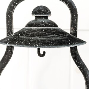 May include: Black metal lantern with a hook on the bottom and a white speckled finish. The lantern has a round top with a small dome and the text "peach + valley" is visible on the top.