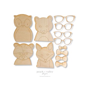 May include: A set of unfinished wooden animal shapes, including an owl, bear, raccoon, and fox. There are also three bow ties and four pairs of glasses included. The shapes are ready to be painted or stained.