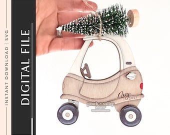 May include: A wooden car ornament with a small artificial Christmas tree on top. The car is painted white and brown and has a red dot on the back. The car has the text "Navy 2021" on the side.