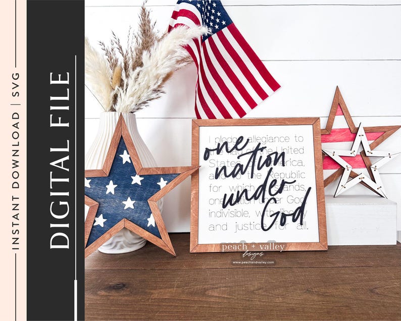May include: A wooden sign with the text "one nation under God" in black script. The sign is surrounded by red, white and blue stars and a small American flag.