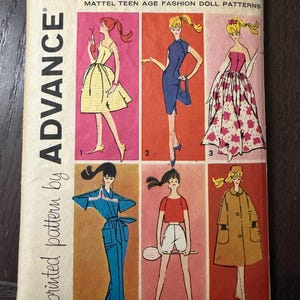 May include: Vintage Barbie doll pattern packet featuring six fashion designs. The cover displays illustrations of the outfits in a retro style, with the Barbie logo and "Advance" branding.