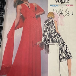 May include: Vintage Very Easy Vogue sewing pattern featuring a red dress with a flowing scarf and a black and white patterned dress. The cover includes the text "Very Easy Vogue" and "American Designer Original" with the signature "Edith Head".