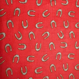 Cowboy- horseshoes on barn red background print fabric by Echo Park paper Company for Riley, Blake designs/ Sold by the half yard