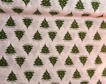 May include: White fabric featuring a repeating pattern of green Christmas trees. Each tree is adorned with small white dots and a star. Small white circles surround the trees, creating a festive holiday design.