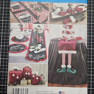May include: A sewing pattern for Christmas decorations. The pattern includes instructions for making a table runner, placemats, napkin rings, a stocking, a gift bag, and a Christmas elf. The pattern is from Simplicity and is size OS.