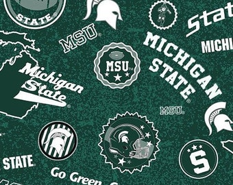 NCAA Michigan Spartans fabric on dark green background /Cotton/ Sold by the half yard