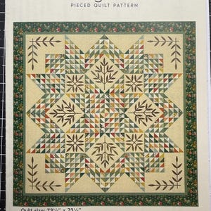 May include: A Laundry Basket Quilts Triangle Star pieced quilt pattern booklet. The cover features a 73.5 inch by 73.5 inch quilt design with a central star, leaf motifs, and a dark green floral border on a cream background with text.
