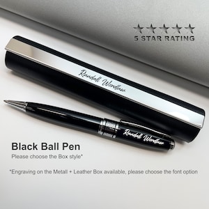 May include: Black ballpoint pen with a silver trim and a black leather case. The pen and case are engraved with the name "Randall Wordlaw".