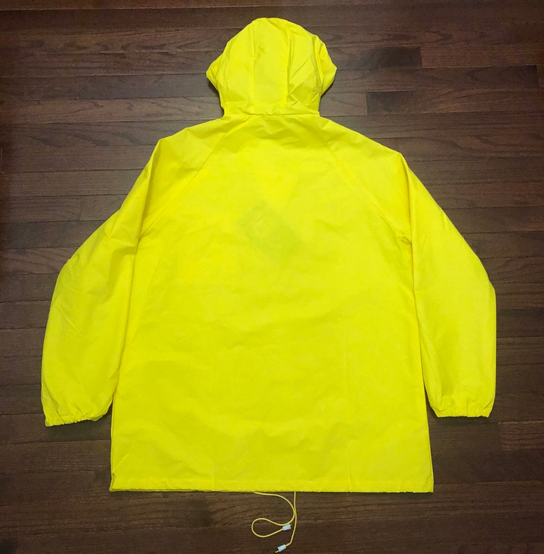 May include: A bright yellow hooded jacket with a drawstring at the bottom.