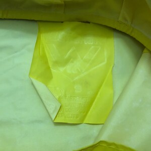 May include: Yellow fabric with a white label that says "W Industries" and has a logo with a "W" inside a triangle.