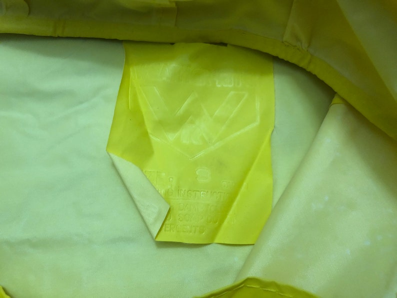 May include: Yellow fabric with a white label that says "W Industries" and has a logo with a "W" inside a triangle.