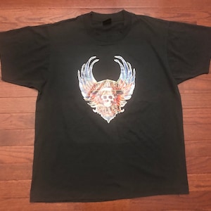 May include: Black t-shirt with a graphic of a skull with wings and the text "WAKITA CYCLES".