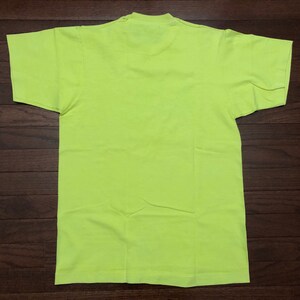 May include: A bright neon yellow t-shirt. The shirt is a basic crew neck style with short sleeves.