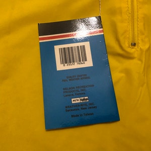 May include: A blue and white tag with a barcode and text that reads "Quality Crafted Foul Weather Apparel Nelson Recreation Products, Inc. Lenexa, Kansas Weather-Rite, Inc. Secaucus, New Jersey Made in Taiwan"