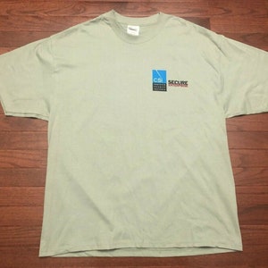 May include: A light green t-shirt with a blue and black logo that says "CSI Secure Enterprise".