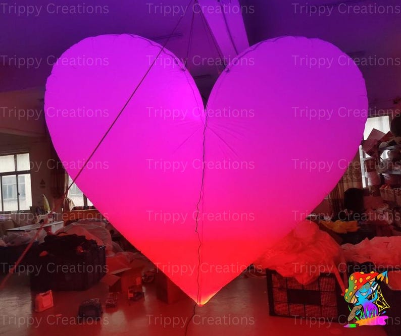Glowing LED inflatable love heart, perfect for romantic events.
