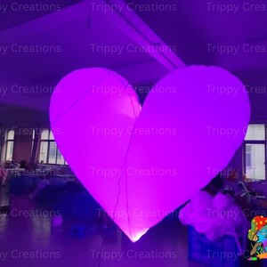 Large glowing LED love heart creating a romantic ambiance at a wedding