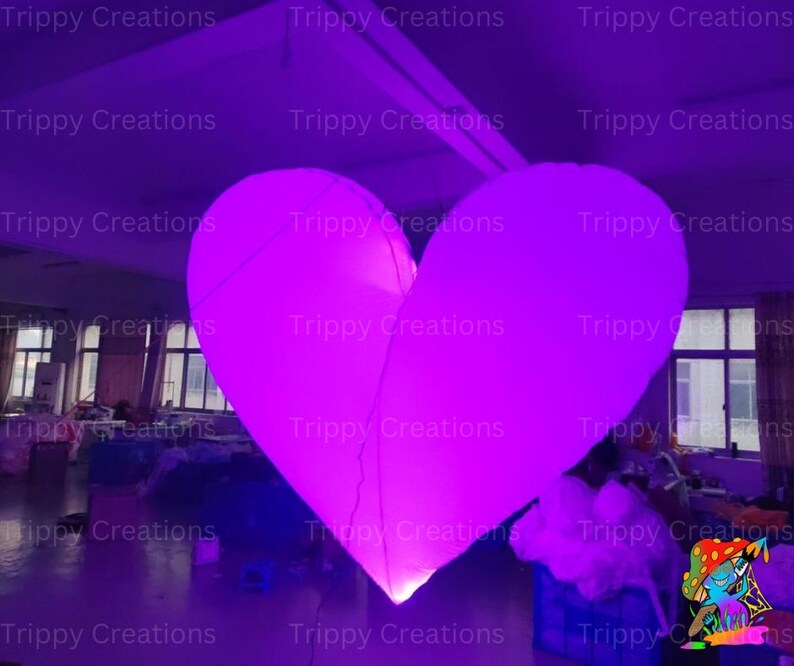Large glowing LED love heart creating a romantic ambiance at a wedding
