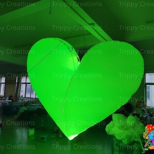 Bright LED inflatable heart adding ambiance to a party setting.