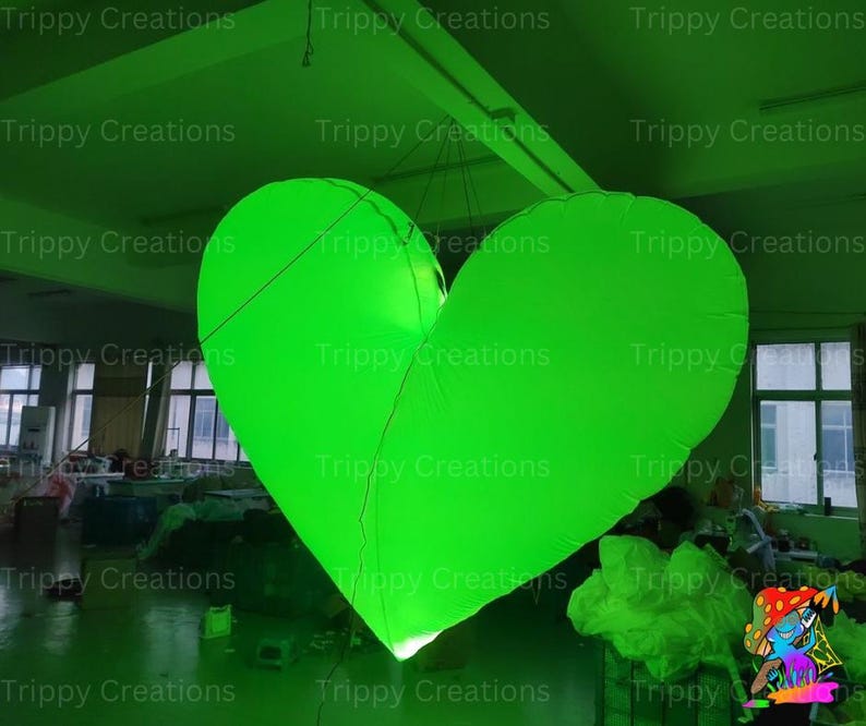 Bright LED inflatable heart adding ambiance to a party setting.