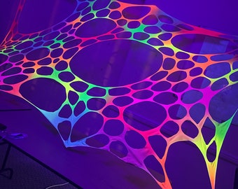 May include: A neon rainbow colored stretchy net with large holes, hanging from the ceiling in a dark room.
