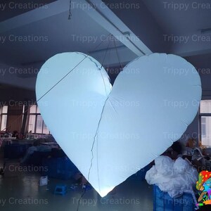 Glowing LED inflatable love heart centerpiece for a wedding reception.