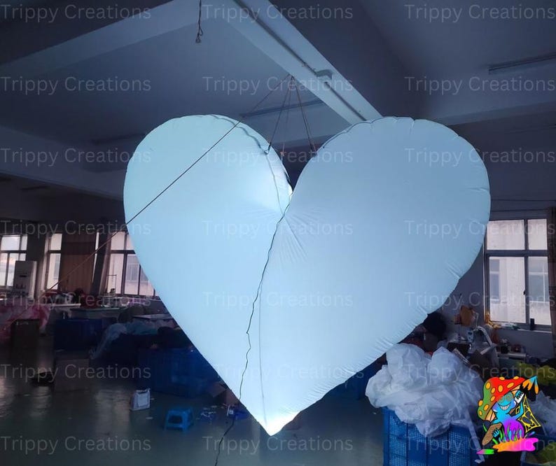 Glowing LED inflatable love heart centerpiece for a wedding reception.