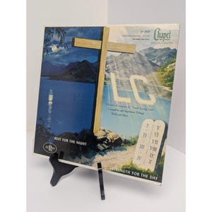 May include: A vintage Chapel Records vinyl record sleeve titled TLC, A Doctor's Prescription for Tender Loving Care. The cover features a split-scene illustration of a moonlit lake and a mountain landscape with a wooden cross and stone tablets.