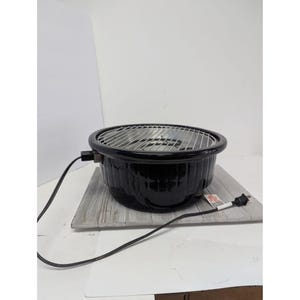 May include: A round, black electric tabletop grill featuring a shiny, smooth exterior finish and a circular metal cooking grate. The appliance includes a black power cord with a standard plug extending from the side of the unit base.