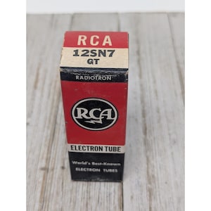 May include: A vintage RCA 12SN7 GT electron tube box. The box is red with black and white text and a circular RCA logo. The box reads "RADIOTRON" and "ELECTRON TUBE". The bottom of the box reads "World's Best-Known ELECTRON TUBES."