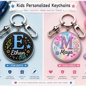 May include: Two circular personalized keychains with silver metal hardware. The left keychain is black with a blue letter E, the name Ethan, and gaming icons. The right keychain has a pastel tie-dye pattern, a purple letter M, the name Maya, and hearts.