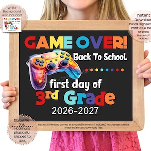 May include: A rectangular sign with a black background featuring a colorful video game controller graphic. The text reads GAME OVER! Back To School first day of 3rd Grade 2026-2027 in various bright colors. The sign is framed in light brown wood.