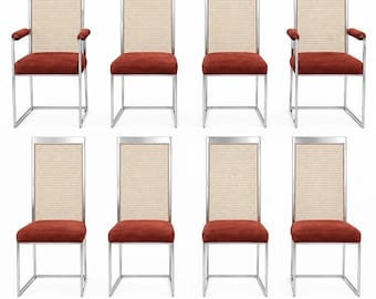 May include: A set of eight chairs featuring chrome metal frames, rectangular backrests with light beige woven cane inserts, and seat cushions upholstered in a deep rust-colored fabric. Two of the chairs include matching rust-colored armrests.