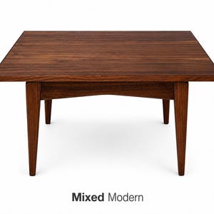 May include: A square, dark brown wooden coffee table with four tapered legs. The table has a simple, modern design and is made of solid wood. The text "Mixed Modern" is at the bottom of the image.
