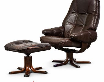 May include: A dark brown leather lounge chair and matching ottoman set. Both pieces feature tufted cushions and are supported by curved, dark wood star-shaped bases. The text "MIXED MODERN" with a red star icon is centered below the furniture.