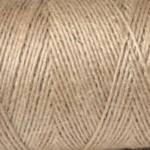 May include: A close-up of a spool of natural brown twine. The twine is made from jute fibres and is ideal for crafting, gardening, and other DIY projects.